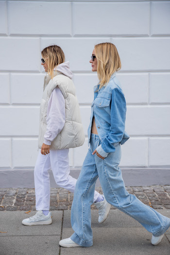 @alessawinter and @mariehindkaer on the streets of copenhagen. @alessawinter wears a all white look with CPH201 and @mariehindkaer the full denim look from head to toe with CPH461. They walk cool across the sidewalk with their sunglasses on.