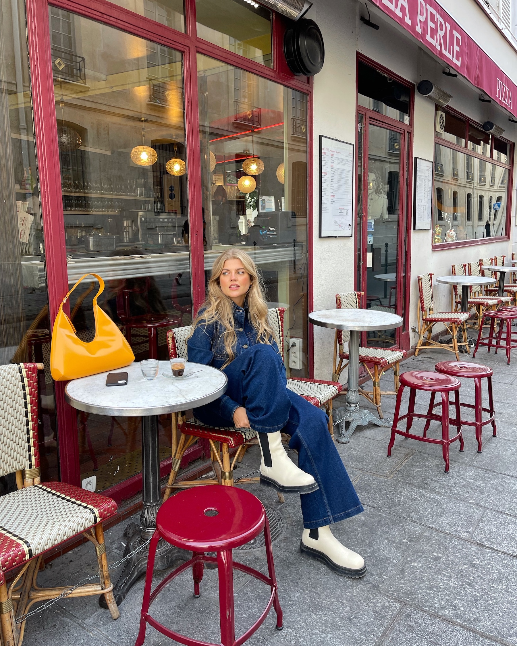 Franziska Nazarenus sitting in a cafe in paris and enjoying her coffee while wearing a all-over denim look in combination with CPH1000 vitello ecru.