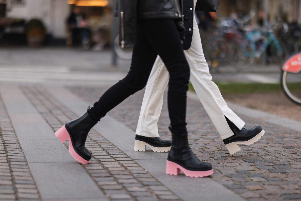 Photo of feeds of two models. One is wearing a boot with a pink sole and the other one a black boot with a creme tone. Lookbook shooting for A/W Copenhagen Studios