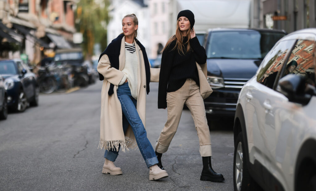 Two scandi female influencers in Copenhagen wearing black and nature CPH boots. Both are wearing a basic scan Outfit in neutral colors.