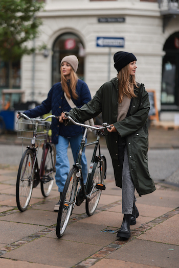 Two scandinavian influencers are walking across the street. Both are wearing boots from Copenhagen Studios. The girls are wearing basic but trendy autumn outfits.