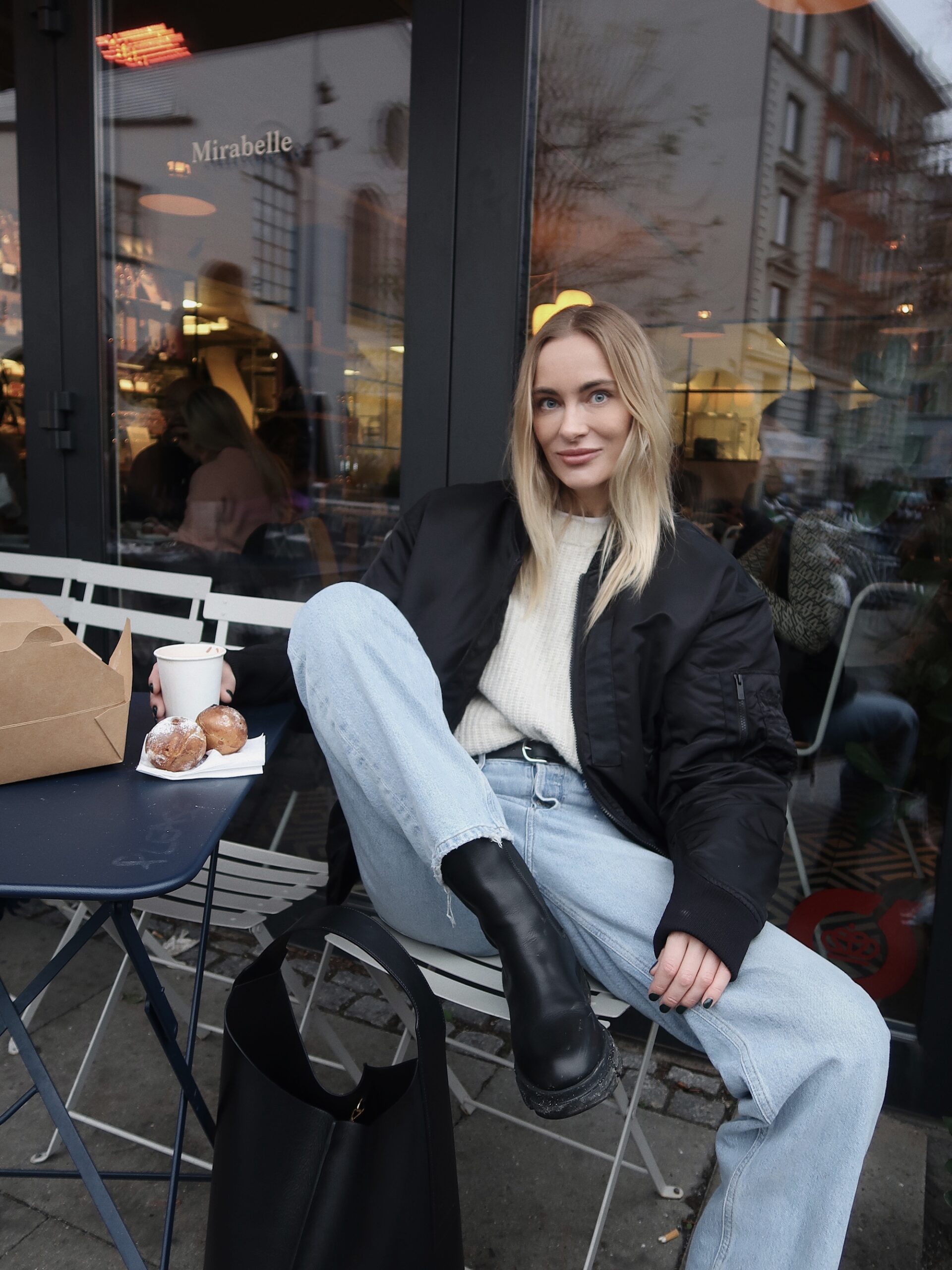Marie Hindkaer sitting in his casual Look with CPH500 vitello black and CPH Bag 1 vitello black at Mirabelle Cafe in Copenhagen and eating some Danish Aebleskiver pancake balls. 