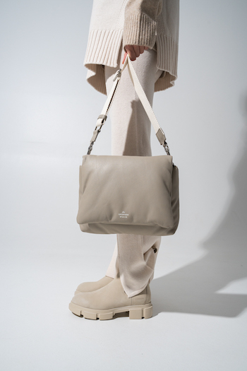 CPH Bag11 kappa stone. Model is holding the bag in her hand. The Model is wearing a beige monochrome look.