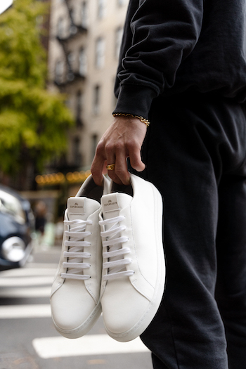 Jonas Kautenburger hold his Copenhagen Studio sneaker CPH4M vitello white in his hands and walking along the streets of New York City.