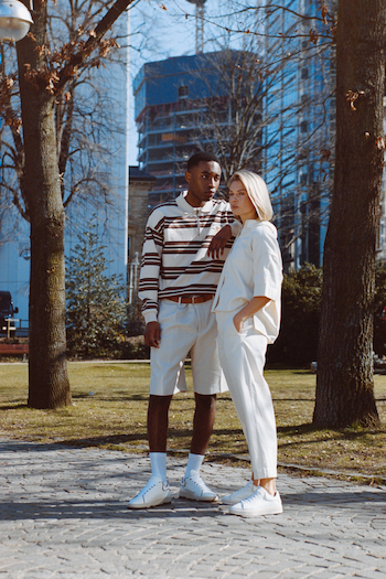 Campaign Picture from our Analogue Street Style Shooting. Two models, one male one female, standing in a park in Frankfurt. Both wearing new Copenhagen Studios Sneakers and wearing an outfit in cream colors.