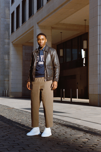 Campaign Picture from our Analogue Street Style Shooting. Male Model is wearing white sneakers from Copenhagen Studios a leatherjacket and a vintage sweater.