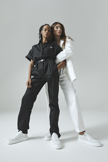 Picture from the Copenhagen Studios Editorial Shooting: The Retro Super Future with Leonie Hanne, Lorena Rae and Najiyah Imani. On the picture you can see two models- Lorena and Najiyah. One is wearing white suit and the CPH332 in beige and the other one is wearing a black overall with the CPH332 in black.