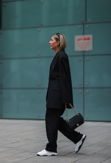@aylin_koenig at the Copenhagen Studios Hamburg store opening. She wears an entirely black look with an oversized suit and her CPH Hamburg 1 vitello white/black.