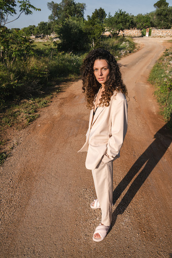 A picture from the High Summer Campaign from Copenhagen Studios with the winner go our challenge at THOC. The model is wearing a suit and sandals in light rose.