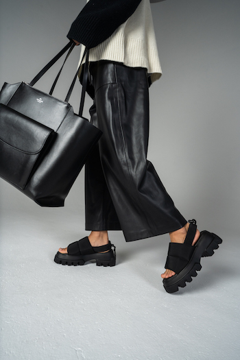 A picture from a Lookbook Shooting for Copenhagen Studios. The Model is wearing a leather pants in black and chunky sandals with nylon: CPH229.