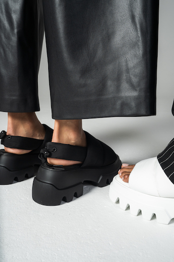 A picture from a Lookbook Shooting for Copenhagen Studios. The Model is wearing a leather pants in black and chunky sandals with nylon: CPH229.