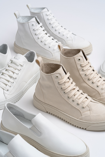 A group picture from shoes on a white floor.