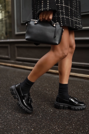 Detail shot from legs. Women wears loafers from Copenhagen Studios with socks.