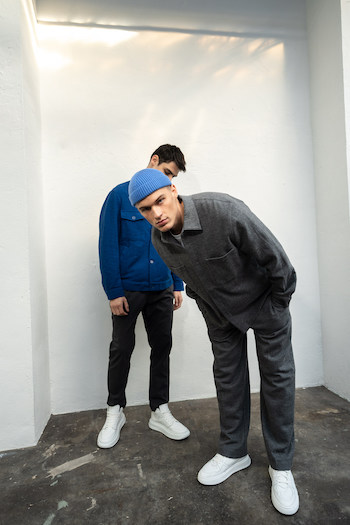Our two male models Bartosz and Rafael are matching on set while wearing some of our new favourite sneaker. One of them is our new CPH73M vitello white. As you can see in the shot we paired it with a dark trousers and a blue jacket to create a nice contrast to the shoes. Bartosz, the model on the right side is wearing one of our all time classics. CPH811M vitello white and combined it with a grey cotton suit and a short blue beanie to break up the fit.