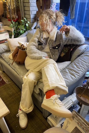 The young creator Katharina Krebs from Copenhagen, Denmark is laying on a sofa wearing our CPH156 material mix off white.