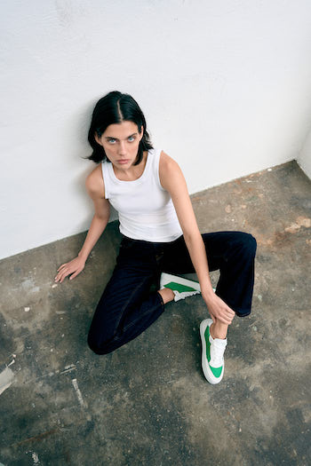 A female model is wearing our CPH428 material mix green, laying on a ground.