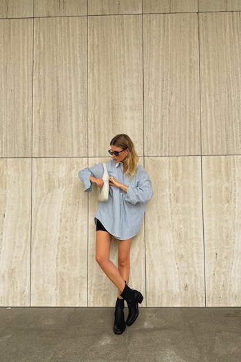 Young content creator Oona in front of a sand-stone wall in Hamburg wearing our new Texano boot style.