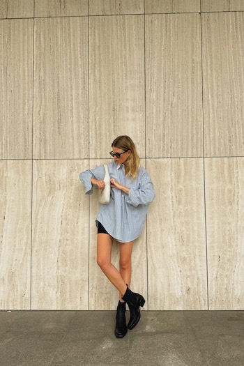 Young content creator Oona in front of a sand-stone wall in Hamburg wearing our new Texano boot style. 