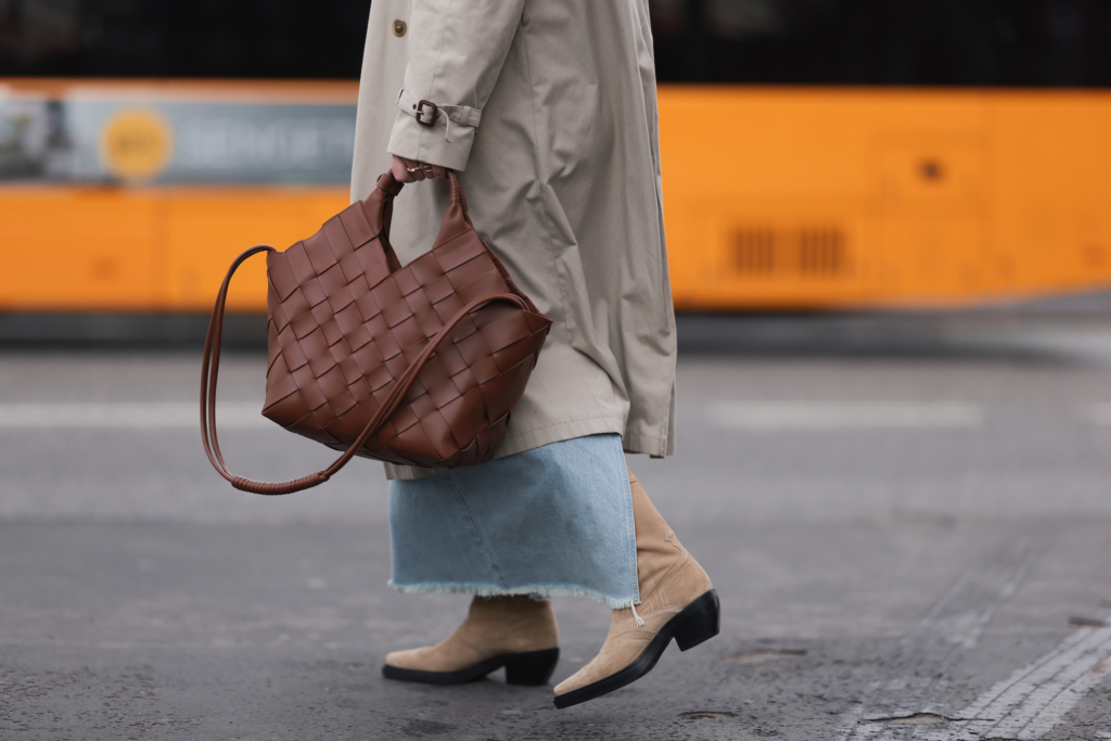 A famous influencer in Copenhagen wearing the soon to be back CPH233 suede sand. in her right hand there is a brown bag.