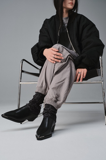 A model sitting in the front of a studio wall wearing our CPH245 vitello black.