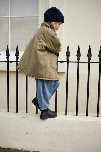 A young girl standing in front of a fence wearing our brand new CPH686 vitello black.