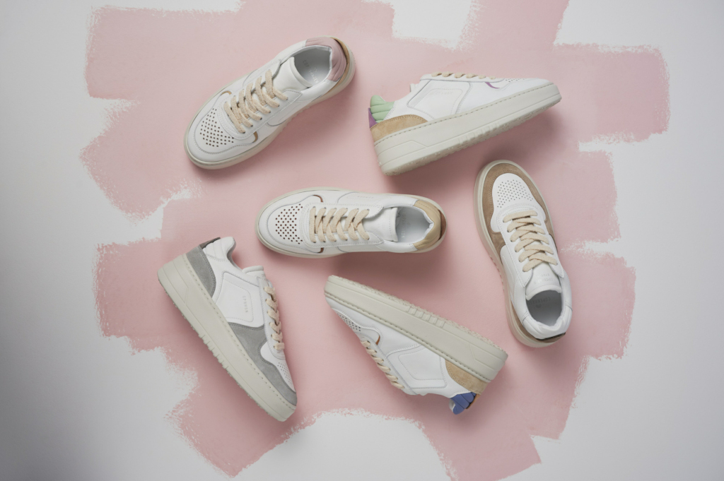 Our brand new Sneaker, the CPH77 leather mix in several colourways, such as rose, blue and sand laying on the ground which is partly white and painted in a rose colour.