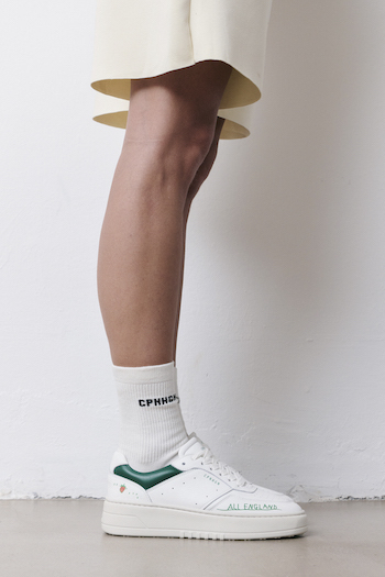 You can see a model posing in the CPH LONDON, wearing a beige outfit with green details.