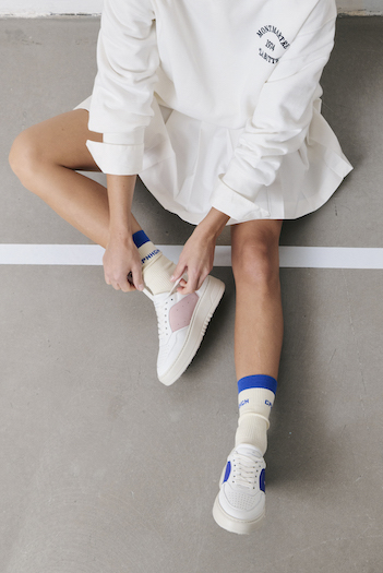 You can see a model posing in the CPH NEW YOKR with a racket and wearing a tennis skirt & sweater.