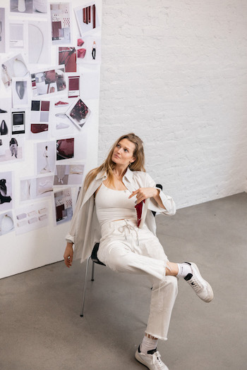 In this image, Toni Garrn sits in front of her collection mooldboard.