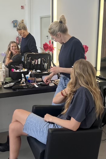 Toni Garrn and her Stylist backstage at our studio day in Berlin.
She is wearing jeans shorts and is getting ready with hair & make-up