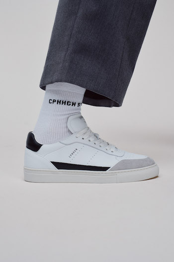 Close up of the "CPH253 x Toni Garrn leather mix white/grey" combined to grey pants.