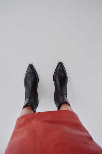 Close up of the "CPH284 x Toni Garrn leather black" combined to a red leather skirt.