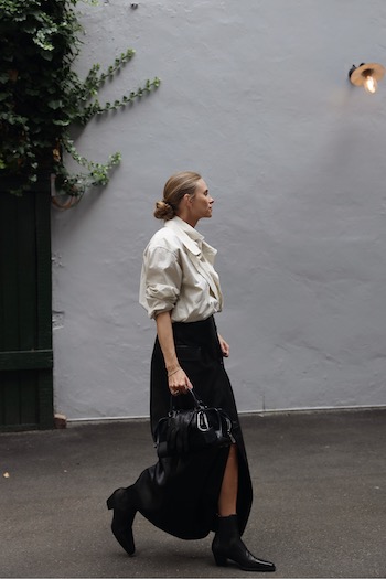 The content creator Tine Andrea spotted at CPHFW wearing our CPH247 leather black to a long maxi skirt and cream blouse.