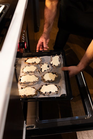 Putting the pastry into the oven. 