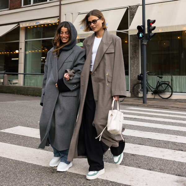 In this image the creator Vera & Bruna walk across a crosswalk, arm in arm wearing Copenhagen Studios shoes. 
