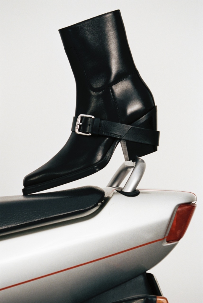 This image showcasts the sleek silhouette of the CPH x 032c ANKLE leather black, an biker boot with a heel and edgy hardware details.