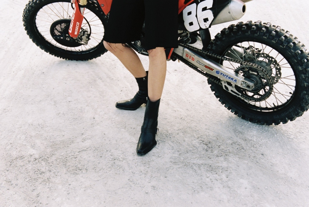 This image shows the CPH x 032c ANKLE leather black being worn with cropped shorts.